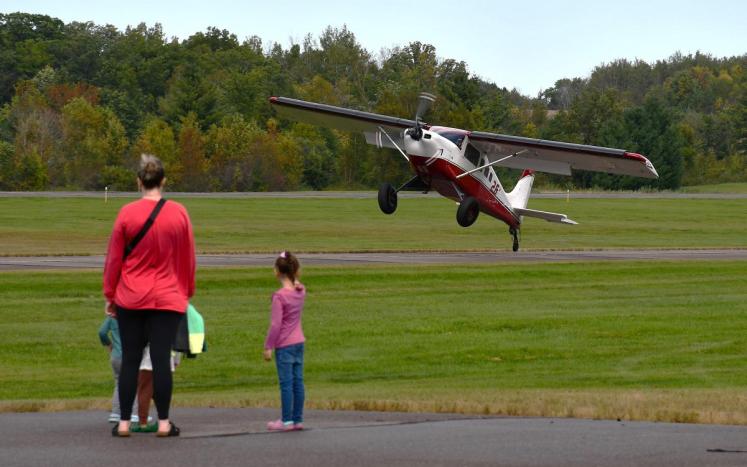  Attendees of the 2024 Mora Fly-in watch pilot demonstrate their short take-off and landing skills.